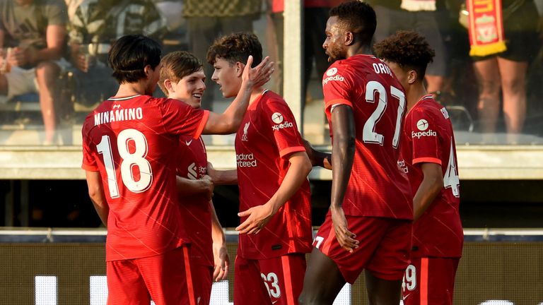 Liverpool players celebrate after the late own goal winner