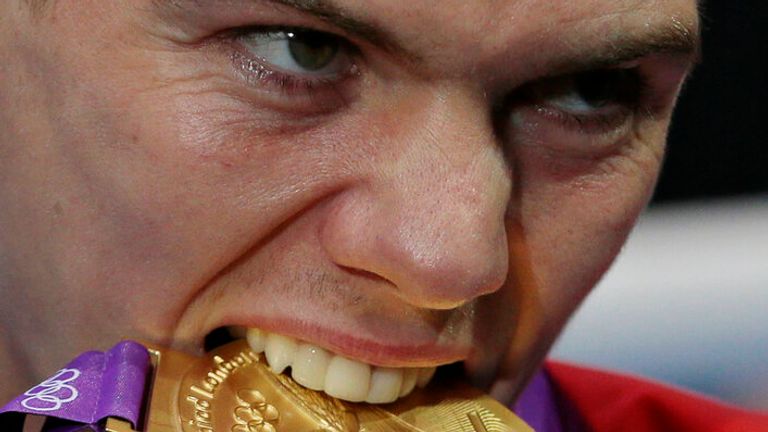 Britain's Luke Campbell bites his gold medal after winning the men's bantamweight 56kg boxing competition at the 2012 Summer Olympics, Saturday, Aug. 11, 2012, in London. (AP Photo/Ivan Sekretarev)