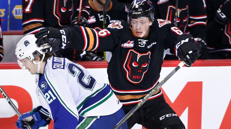 Swift Current Broncos player Owen Blocker, lt, collides with Calgary Hitmen player Luke Prokop during WHL (Western Hockey League) hockey action in Calgary, Alta., on Friday, Dec. 7, 2018. (Larry MacDougal via AP)