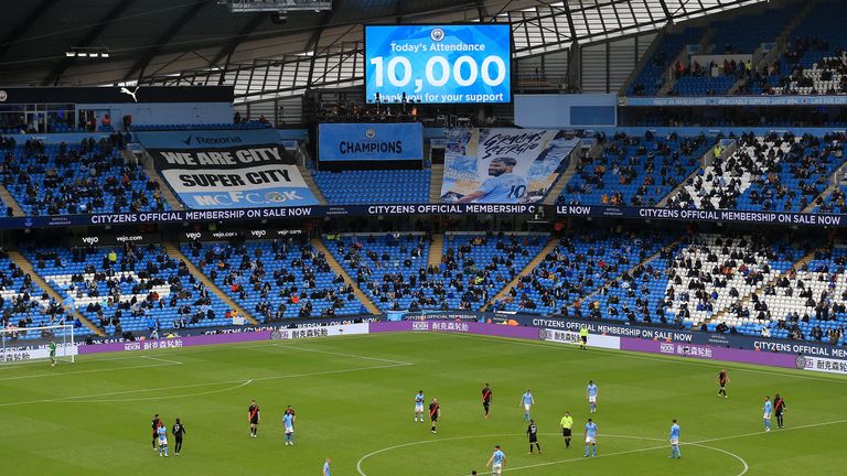 Fans are seen as an attendance of 10,000 spectators is announced during the Premier League match between Manchester City and Everton at Etihad Stadium
