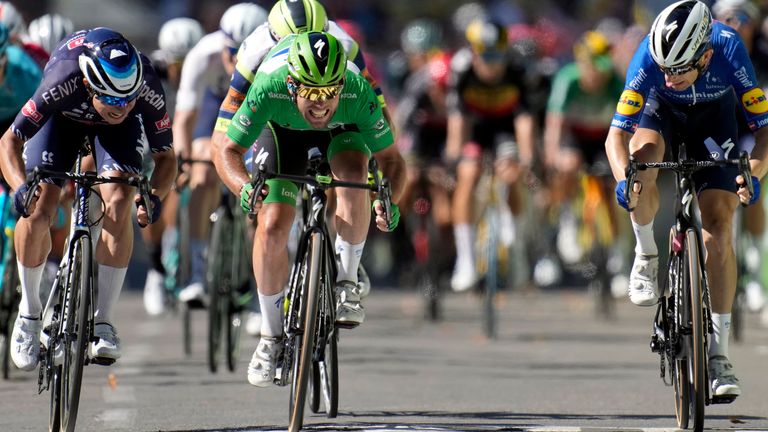 Mark Cavendish, wearing the best sprinter's green jersey, sprints to win the thirteenth stage of the Tour de France