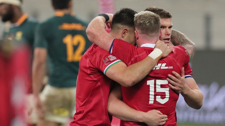 British and Irish Lions' Conor Murray, left, with teammates Stuart Hogg (15), and Owen Farrell celebrate after defeating South Africa in the first rugby union test between South Africa's Springboks and the British and Irish Lions at the Cape Town Stadium, in Cape Town, South Africa, Saturday, July 24, 2021. (AP Photo/Halden Krog)