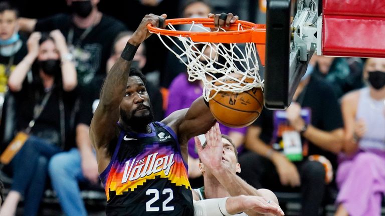 Phoenix Suns center Deandre Ayton (22) dunks against Milwaukee Bucks center Brook Lopez (11) during the second half of Game 1 of basketball&#39;s NBA Finals, Tuesday, July 6, 2021, in Phoenix.