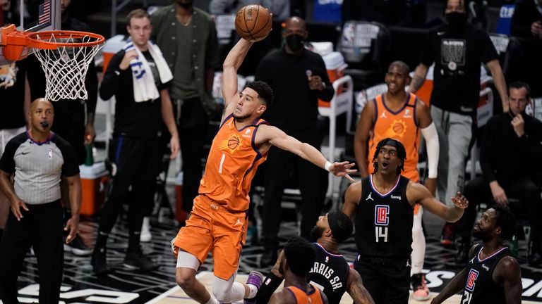 Phoenix Suns&#39; Devin Booker, center, goes up for a dunk during the first half in Game 6 of the NBA basketball Western Conference Finals against the Los Angeles Clippers Wednesday, June 30, 2021, in Los Angeles. (AP Photo/Jae C. Hong)


