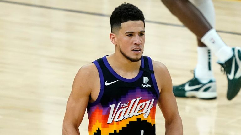 Phoenix Suns guard Devin Booker (1) pumps his fists after a basket against the Milwaukee Bucks during the second half of Game 1 of basketball&#39;s NBA Finals, Tuesday, July 6, 2021, in Phoenix. 