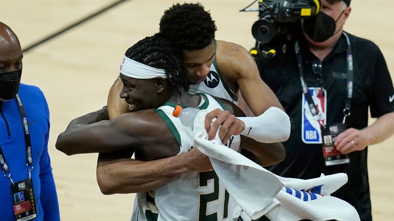 Milwaukee Bucks forward Giannis Antetokounmpo, top, celebrates with guard Jrue Holiday (21) after the Bucks defeated the Phoenix Suns in Game 5 of basketball&#39;s NBA Finals, Saturday, July 17, 2021, in Phoenix.