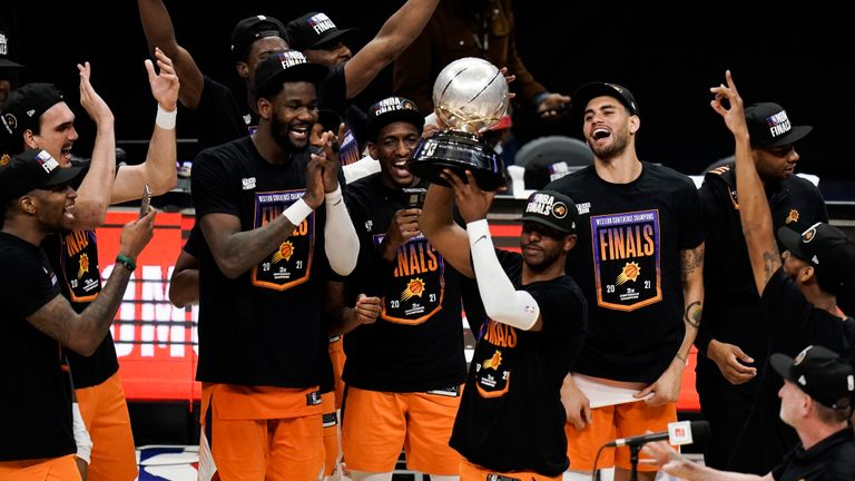 Phoenix Suns&#39; Chris Paul hoists the trophy as he and his teammates celebrate after defeating the Los Angeles Clippers in Game 6 of the NBA basketball Western Conference Finals Wednesday, June 30, 2021, in Los Angeles. (AP Photo/Jae C. Hong)


