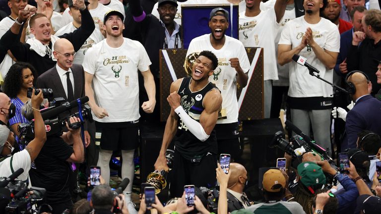 Giannis Antetokounmpo celebrates with the Bill Russell trophy for Finals MVP