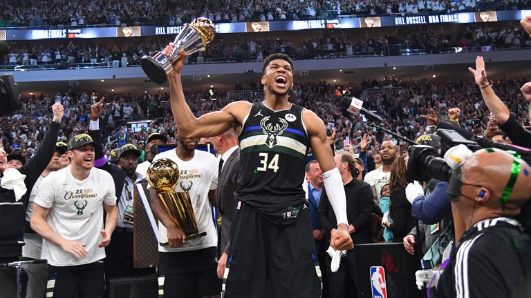 MILWAUKEE, WI - JULY 20: Giannis Antetokounmpo #34 of the Milwaukee Bucks celebrates after receiving the Bill Russell Finals MVP Award after winning Game Six of the 2021 NBA Finals against the Phoenix Suns on July 20, 2021 at Fiserv Forum in Milwaukee, Wisconsin. NOTE TO USER: User expressly acknowledges and agrees that, by downloading and/or using this Photograph, user is consenting to the terms and conditions of the Getty Images License Agreement. Mandatory Copyright Notice: Copyright 2021 NBAE (Photo by Jesse D. Garrabrant/NBAE via Getty Images) 