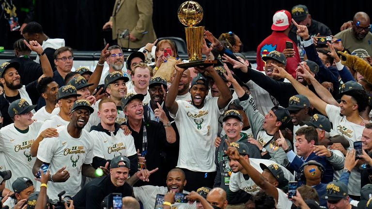 Khris Middleton lifts the Larry O'Brien trophy as the Milwaukee Bucks celebrate the 2021 NBA Championship