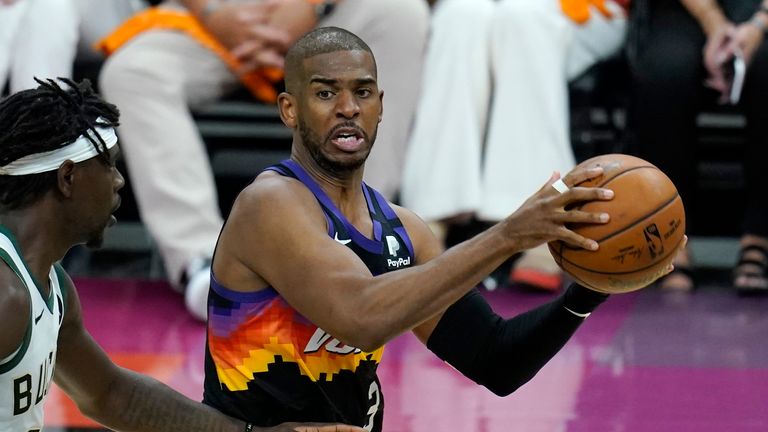 Phoenix Suns guard Chris Paul (3) drives past Milwaukee Bucks guard Jrue Holiday, left, during the second half of Game 1 of basketball&#39;s NBA Finals, Tuesday, July 6, 2021, in Phoenix. The Suns defeated the Bucks 118-105.