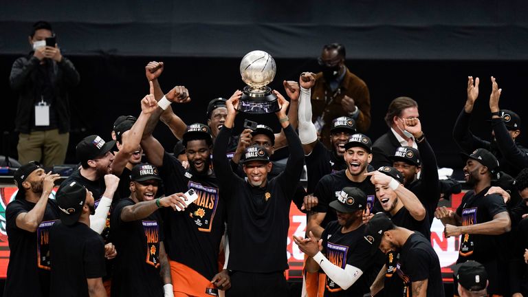 Phoenix Suns head coach Monty Williams, center, hoists the trophy as he and his players celebrate after defeating the Los Angeles Clippers in Game 6 of the NBA basketball Western Conference Finals Wednesday, June 30, 2021, in Los Angeles. (AP Photo/Jae C. Hong)


