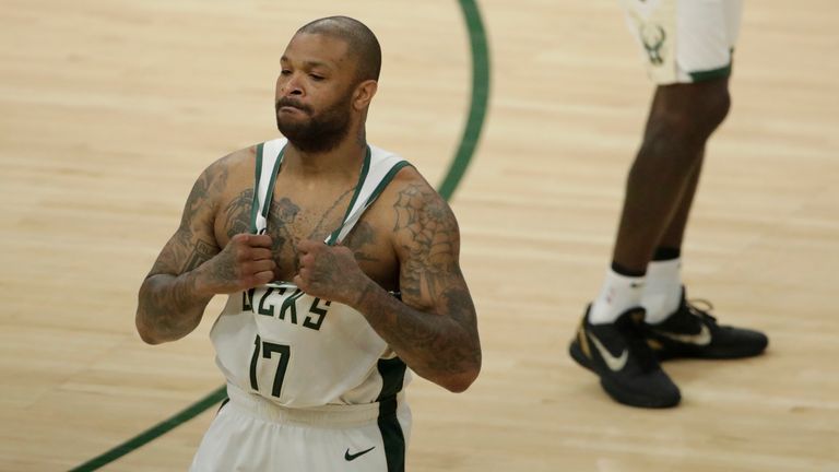 Milwaukee Bucks' P.J. Tucker adjusts his jersey before the first half of Game 5 of the NBA Eastern Conference Finals against the Atlanta Hawks Thursday, July 1, 2021, in Milwaukee. (AP Photo/Aaron Gash) 