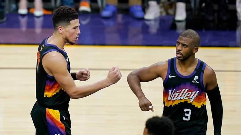 Phoenix Suns guard Devin Booker, left, reacts with guard Chris Paul (3) during the first half of Game 2 of basketball's NBA Finals against the Milwaukee Bucks, Thursday, July 8, 2021, in Phoenix. (AP Photo/Ross D. Franklin)


