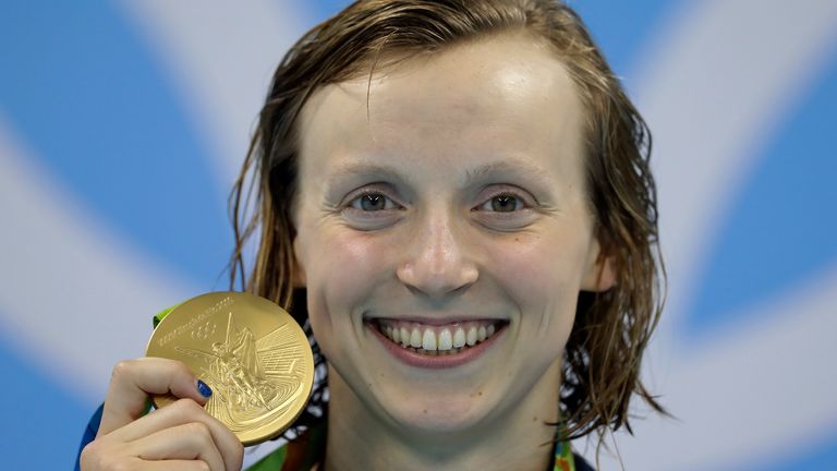 United States' Katie Ledecky shows off her gold medal during the ceremony for the women's 200-meter freestyle final during the swimming competitions at the 2016 Summer Olympics, Tuesday, Aug. 9, 2016, in Rio de Janeiro, Brazil. (AP Photo/Michael Sohn)