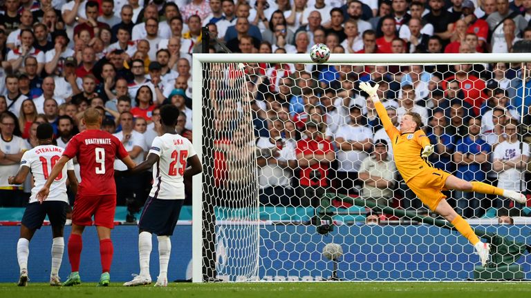 Pickford leaps to his right but doesn't have enough reaction time to make the save