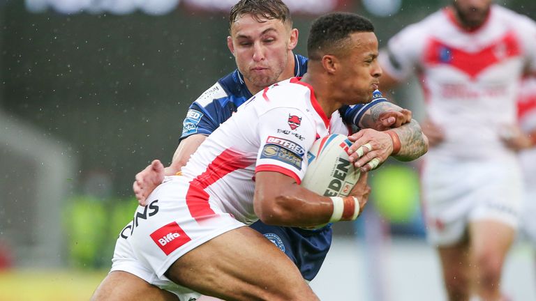 Picture by Alex Whitehead/SWpix.com - 04/07/2021 - Rugby League - Betfred Super League - St Helens v Wigan Warriors - Totally Wicked Stadium, St Helens, England - St Helens' Regan Grace is tackled by Wigan's Sam Powell.