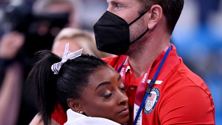 Simone Biles was comforted by a USA coach during the women's team event (AP)