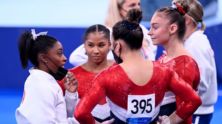 Simone Biles speaks to her United States teammates after she withdraws from the women's team final