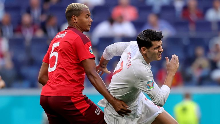 Alvaro Morata of Spain is challenged by Manuel Akanji