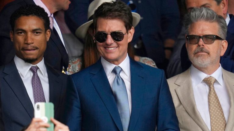 US actor Tom Cruise, centre in the stands has his photo taken by a member of the crowd as he watches the men&#39;s singles final between Serbia&#39;s Novak Djokovic and Italy&#39;s Matteo Berrettini on day thirteen of the Wimbledon Tennis Championships in London, Sunday, July 11, 2021. (AP Photo/Kirsty Wigglesworth)