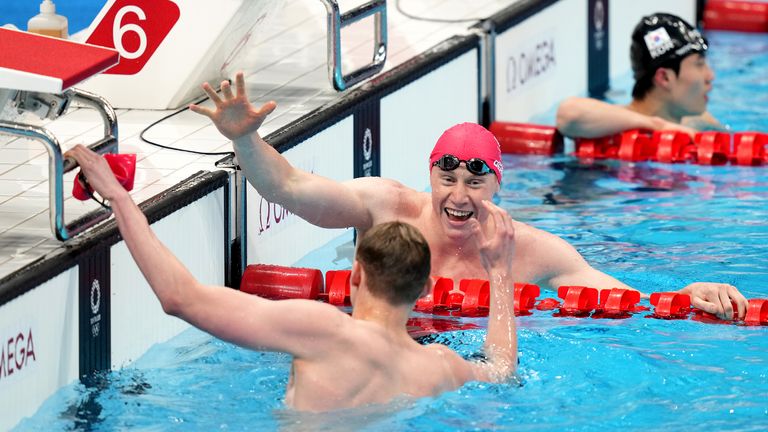 Great Britain&#39;s Tom Dean celebrates winning the Men&#39;s 200m Freestyle with teammate Duncan Scott who took silver
