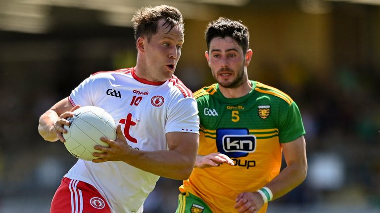 Kieran McGeary of Tyrone in action against Ryan McHugh of Donegal