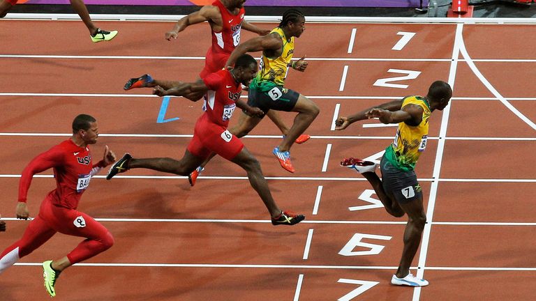 Jamaica's Usain Bolt crosses the finish line to win gold in the men's 100-meter final during the athletics in the Olympic Stadium at the 2012 Summer Olympics, London, Sunday, Aug. 5, 2012. (AP Photo/Christophe Ena)