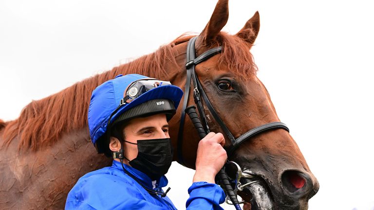 William Buick poses alongside Hurricane Lane after their victory in the Irish Derby last month