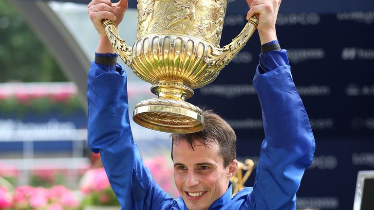 William Buick holds aloft the King George trophy after victory on Adayar