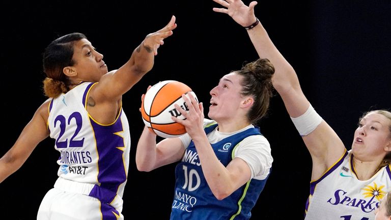 Minnesota Lynx&#39;s Jessica Shepard, center, shoots as Los Angeles Sparks guard Arella Guirantes, left, and Lauren Cox defend during the second half of a WNBA basketball game Sunday, July 11, 2021, in Los Angeles. The Lynx won 86-61. 