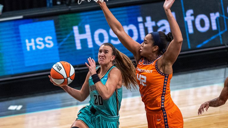 New York Liberty guard Sabrina Ionescu (20) attempts to shoot the ball as Connecticut Sun forward Brionna Jones (42) blocks it during the first half of a WNBA basketball game Sunday, July 11, 2021, in New York.