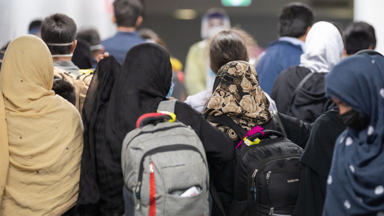 Repatriated members of the public disembark at an Australian International Airport after arriving on a Royal Australian Air Force KC-30A aircraft from Afghanistan