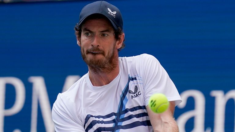 Andy Murray, of Great Britain, returns a shot to Stefanos Tsitsipas, of Greece, during the first round of the US Open tennis championships, Monday, Aug. 30, 2021, in New York. (AP Photo/Seth Wenig)