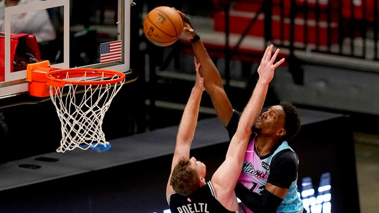 Miami Heat center Bam Adebayo (13) dunks over San Antonio Spurs center Jakob Poeltl (25) during the second half of an NBA basketball game, Wednesday, April 28, 2021, in Miami. The Heat won 116-111. (AP Photo/Lynne Sladky)