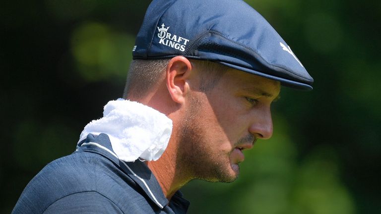 Bryson DeChambeau wears a towel on his neck during high temperatures after teeing off on the second hole during the second round of the BMW Championship golf tournament, Friday, Aug. 27, 2021, at Caves Valley Golf Club in Owings Mills, Md. (AP Photo/Nick Wass)