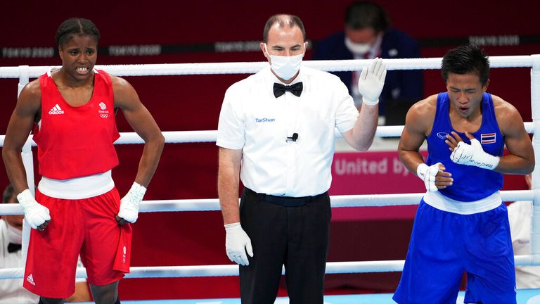 Thailand's SEESONDEE Sudaporn (R) reacts after winning the Boxing Women's Light (57-60kg) Quarterfinal against Great Britain's DUBOIS Caroline (red) and at Kokugikan in Tokyo on Aug. 3, 2021.( The Yomiuri Shimbun via AP Images )