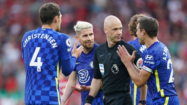 Chelsea players surround referee Anthony Taylor in protest at Liverpool being awarded a penalty