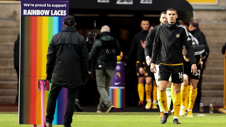 WOLVERHAMPTON, ENGLAND - DECEMBER 12: Conor Coady of Wolverhampton Wanderers leads the team out past Premier League LGBT Rainbow Laces branding during the Premier League match between Wolverhampton Wanderers and Aston Villa at Molineux on December 12, 2020 in Wolverhampton, United Kingdom. The match will be played without fans, behind closed doors as a Covid-19 precaution. (Photo by James Williamson - AMA/Getty Images)