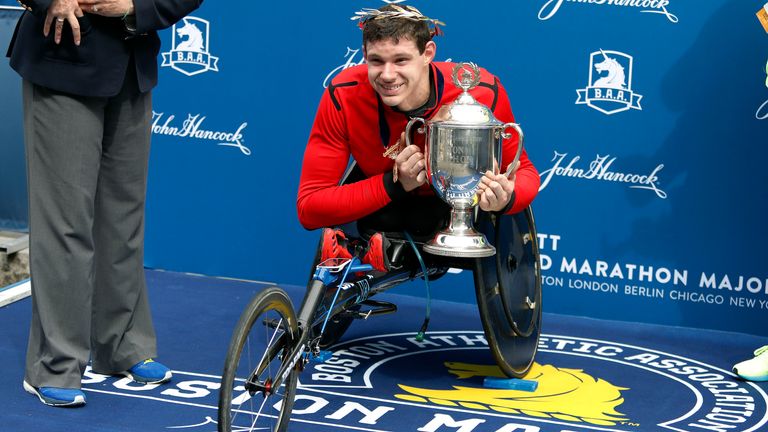 Romanchuk holds the trophy after winning the men's wheelchair race at the 123rd Boston Marathon in April 2019