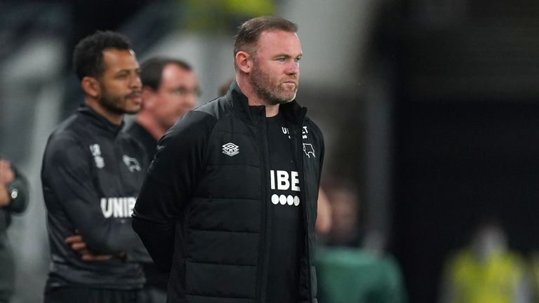 Wayne Rooney watches on from the touchline