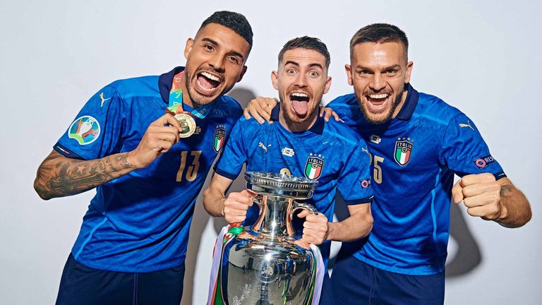 Emerson, Jorginho and Rafael Toloi of Italy pose with The Henri Delaunay Trophy during an Italy Portrait Session following their side's victory in the UEFA Euro 2020 Championship Final between Italy and England at Wembley Stadium on July 11, 2021 in London, England.