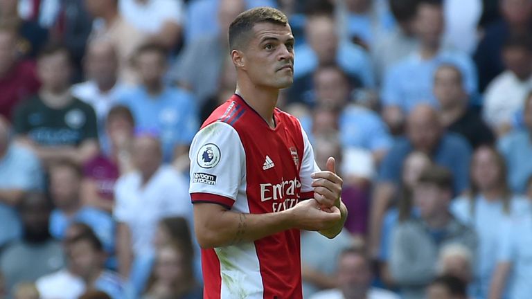 Granit Xhaka leaves the pitch after being sent off (AP)