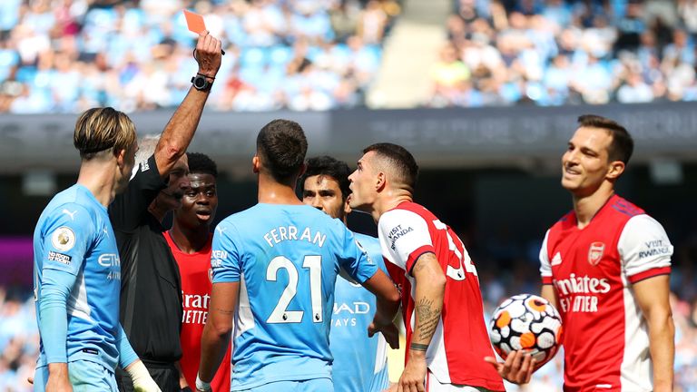 Granit Xhaka is shown a red card by referee Martin Atkinson