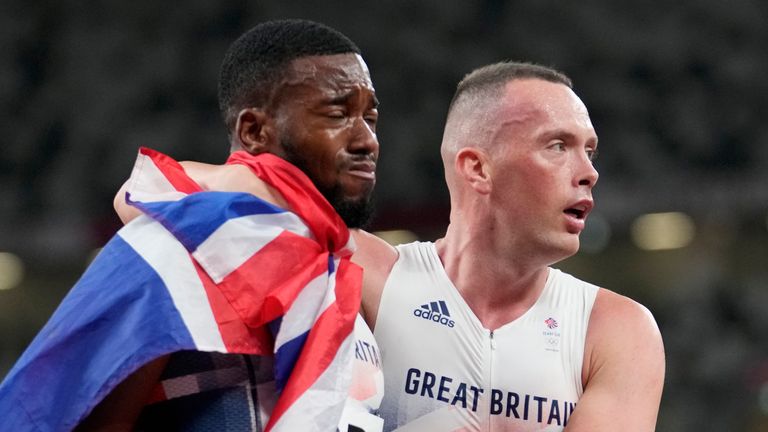 Nethaneel Mitchell-Blake, of Britain, is consoled by a teammate after the men...s 4x100-meter relay at the 2020 Summer Olympics, Friday, Aug. 6, 2021, in Tokyo. (AP Photo/David J. Phillip)