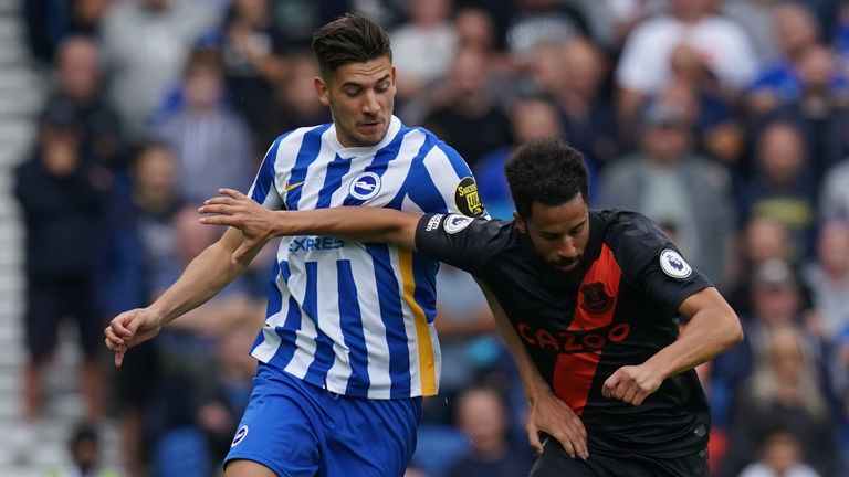 Jakub Moder and Andros Townsend battle for the ball 