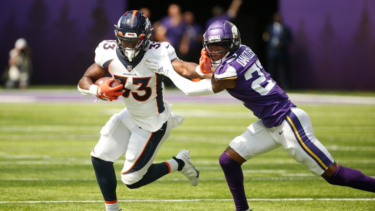 Denver Broncos running back Javonte Williams (33) looks to hold off Minnesota Vikings cornerback Cameron Dantzler (27) during the first half their preseason opener (AP Photo/Bruce Kluckhohn)