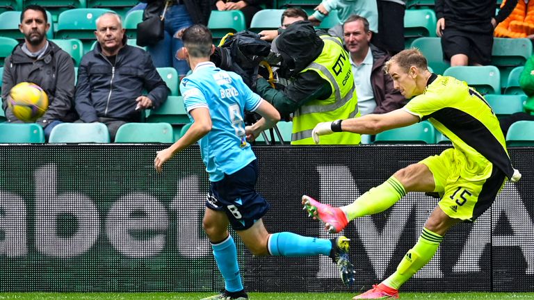 Celtic goalkeeper Joe Hart is closed down by Dundee's Shaun Byrne 