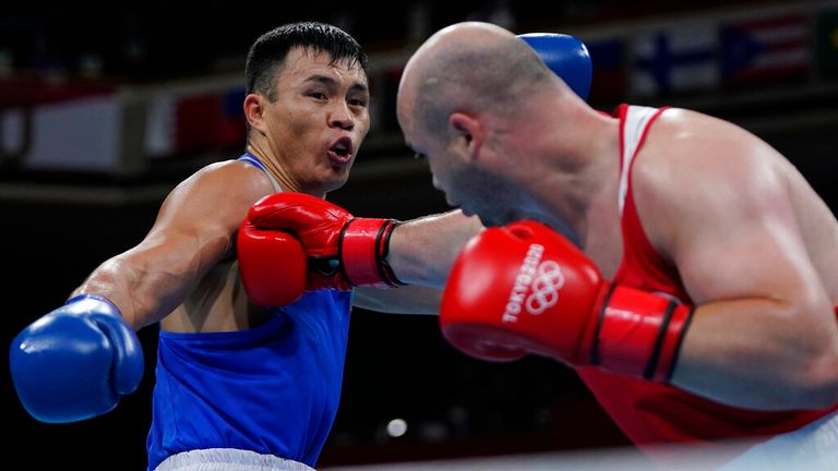 Ivan Veriasov, of the Russian Olympic Committee, right, exchanges punches with Kazakhstan...s Kamshybek Kunkabayev during their men...s super heavyweight over 91-kg boxing match at the 2020 Summer Olympics, Sunday, Aug. 1, 2021, in Tokyo, Japan. (AP Photo/Themba Hadebe, Pool) 