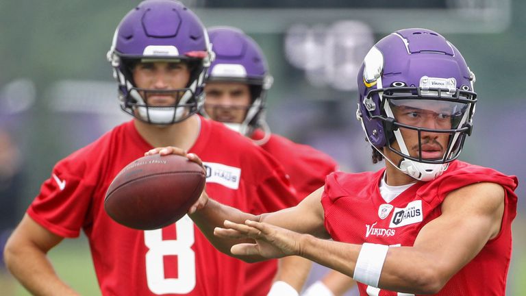 Minnesota Vikings quarterback Kellen Mond (11) passes in front of quarterback Kirk Cousins (8) during a NFL training camp Friday, July 30, 2021, in Eagan, Minn. (AP Photo/Bruce Kluckhohn)